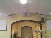 Speakers being installed with scafolding and projector screens